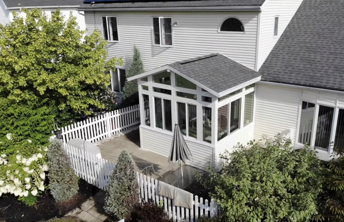 Aerial view of durable white-framed sunroom attached to house in Buckeye, AZ